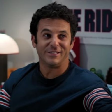 Fred Savage is lying on the bed.